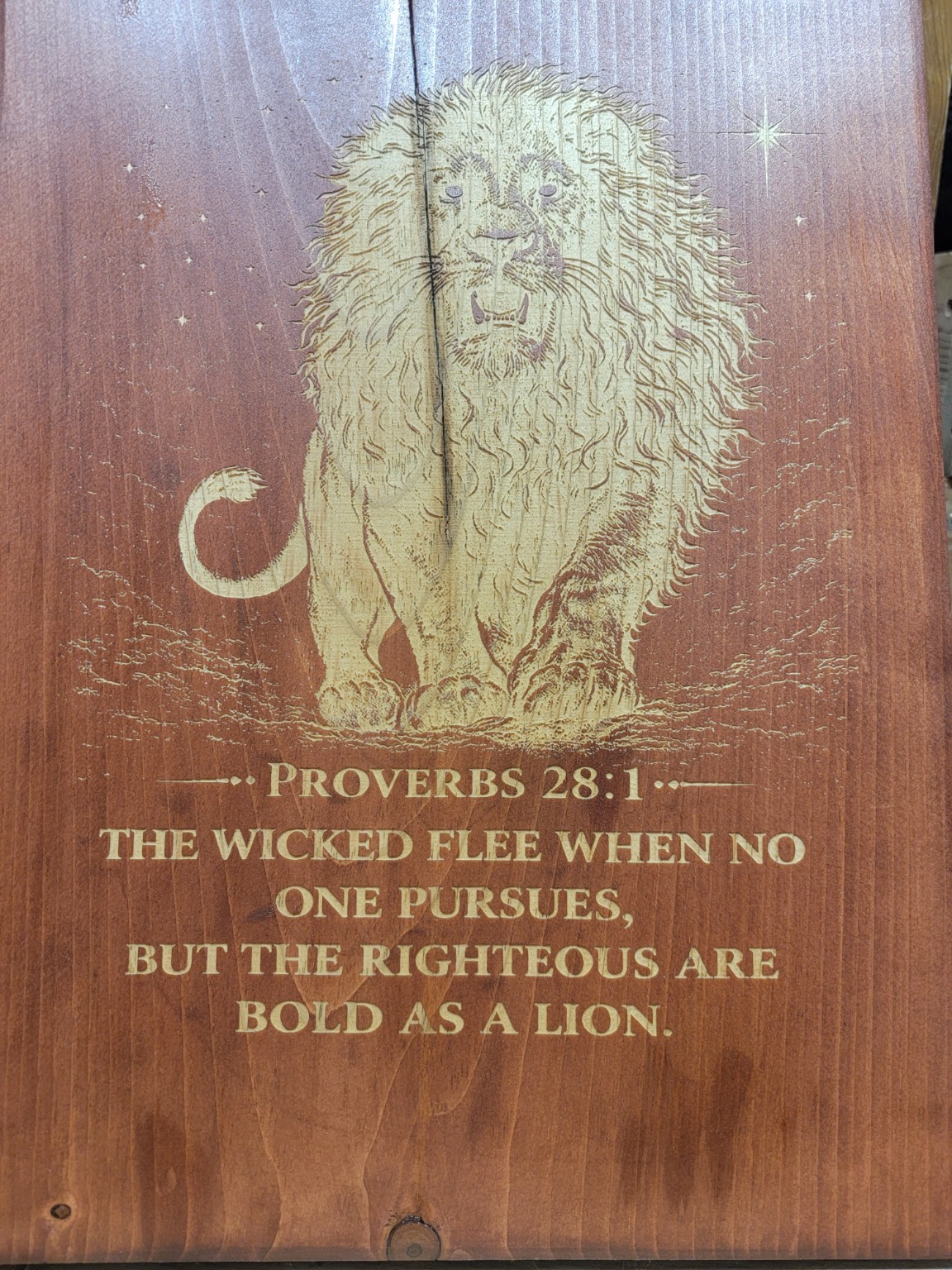 Wood engraved with scripture and praying hands